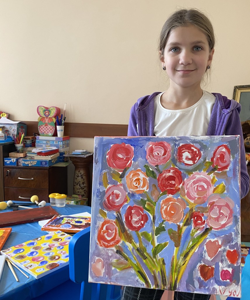 A displaced child's painting of flowers at a Painting the Future art workshop in a hospital in Ukraine.